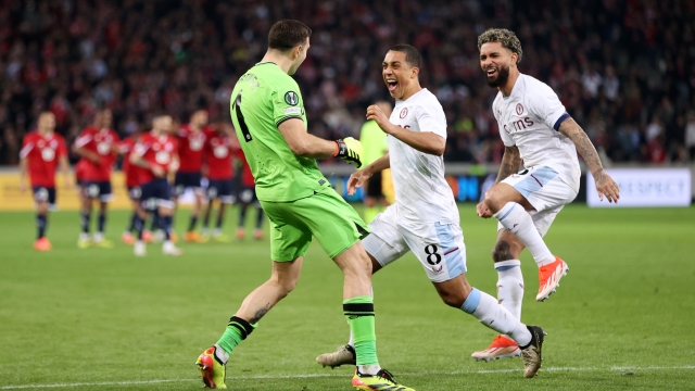 LILLE, FRANCE - APRIL 18: Emiliano Martinez, Youri Tielemans and Douglas Luiz of Aston Villa celebrate after the team's victory in the penalty shoot out in the UEFA Europa Conference League 2023/24 Quarter-final second leg match between Lille OSC and Aston Villa at Stade Pierre-Mauroy on April 18, 2024 in Lille, France. (Photo by Alex Pantling/Getty Images)