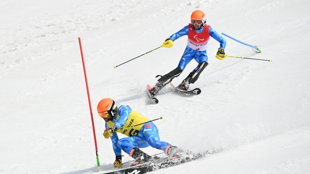(220313) -- BEIJING, March 13, 2022 (Xinhua) -- Giacomo Bertagnolli (top) of Italy and his guide Andrea Ravelli react during the para alpine skiing Men's Slalom Vision Impaired of Beijing 2022 Winter Paralympic Games at National Alpine Skiing Centre in Yanqing District, Beijing, capital of China, March 13, 2022. (Xinhua/Sun Fei) (Photo by Sun Fei / XINHUA / Xinhua via AFP)