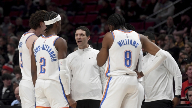 Oklahoma City Thunder head coach Mark Daigneault, center, speaks with his team during time out during the first half of an NBA basketball game against the Portland Trail Blazers in Portland, Ore., Wednesday, March 6, 2024. (AP Photo/Steve Dykes)