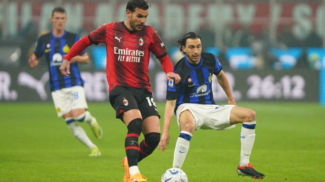AC Milan's Theo Hernandez fights for the ball with    Inter?s Matteo Darmian during the Serie A soccer  match between Milan and Inter  at  San Siro stadium   , north Italy - Monday  22 , April , 2024. Sport - Soccer . (Photo by Spada/LaPresse)
