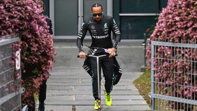 Mercedes' British driver Lewis Hamilton (C) rides a scooter ahead of the Formula One Chinese Grand Prix race at the Shanghai International Circuit in Shanghai on April 21, 2024. (Photo by Pedro Pardo / AFP)