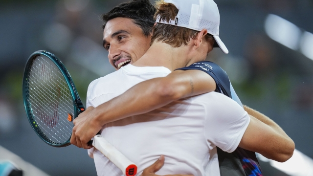 Italian tennis players Jannik Sinner, left, and Lorenzo Sonego embrace during the Mutua Madrid Open tennis tournament in Madrid, Saturday, April 27, 2024. (AP Photo/Manu Fernandez)