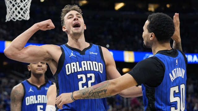 Orlando Magic forward Franz Wagner (22) celebrates with guard Cole Anthony (50) after making a basket and drawing a foul against the Cleveland Cavaliers during the second half of Game 4 of an NBA basketball first-round playoff series, Saturday, April 27, 2024, in Orlando, Fla. (AP Photo/John Raoux)