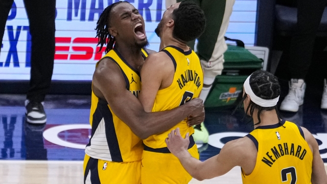 Indiana Pacers guard Tyrese Haliburton (0) is hugged by forward Aaron Nesmith (23) after hitting the game-winning basket against the Milwaukee Bucks during overtime in Game 2 in an NBA basketball first-round playoff series, Friday, April 26, 2024, in Indianapolis. (AP Photo/Michael Conroy)