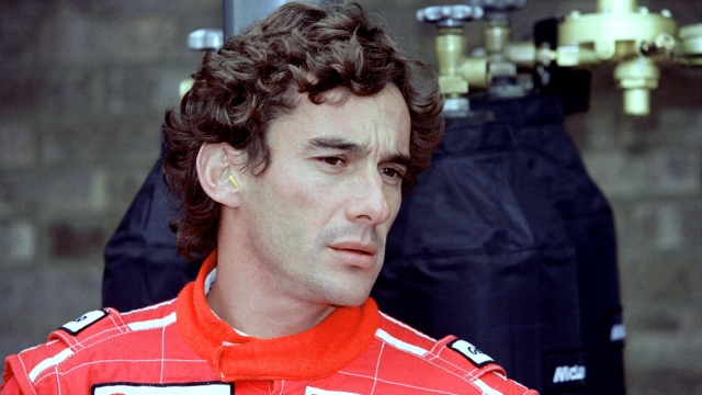 (FILES) Brazilian Formula One driver Ayrton Senna checks his times after todays offical practice, on April 10, 1993 for the upcoming European Grand Prix in Donington. A legend intact. Thirty years after his death at the age of 34 on the Italian Imola circuit on 1 May 1994, the Brazilian Ayrton Senna is still adored, and his death has helped to improve safety in Formula 1. While safety had already made progress over the previous twenty years, thanks to the initiative of drivers such as three-time world champion Jackie Stewart, Senna's death triggered a new effort, as demonstrated by the deformable structures, drivers' equipment and clearance zones on the circuits. (Photo by Jean-Loup GAUTREAU / AFP)