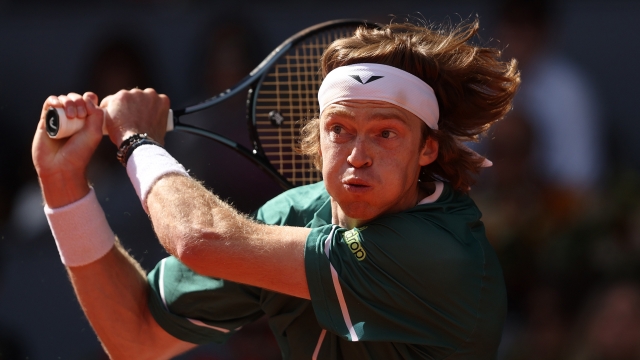 MADRID, SPAIN - MAY 03: Andrey Rublev plays a backhand against Taylor Fritz of USA during the Men's Singles semi-final match on Day Eleven of Mutua Madrid Open at La Caja Magica on May 03, 2024 in Madrid, Spain. (Photo by Julian Finney/Getty Images)