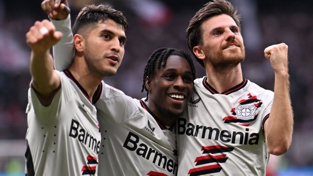 Bayer Leverkusen's Dutch defender #30 Jeremie Frimpong (C), Bayer Leverkusen's German midfielder #07 Jonas Hofmann (R) and Bayer Leverkusen's Argentine midfielder #25 Exequiel Palacios celebrate scoring a goal during the German first division Bundesliga football match between Eintracht Frankfurt and Bayer 04 Leverkusen in Frankfurt am Main, western Germany on May 5, 2024. (Photo by Kirill KUDRYAVTSEV / AFP) / DFL REGULATIONS PROHIBIT ANY USE OF PHOTOGRAPHS AS IMAGE SEQUENCES AND/OR QUASI-VIDEO