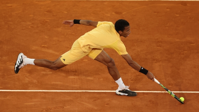 MADRID, SPAIN - MAY 05: Felix Auger-Aliassime of Canada stretches for the ball during the Men's Singles Final match against Andrey Rublev on Day Thirteen of Mutua Madrid Open at La Caja Magica on May 05, 2024 in Madrid, Spain. (Photo by Julian Finney/Getty Images)