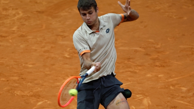 epa11309248 Flabio Cobolli of Italy in action during his round of 16 tennis match against Karen Khachanov of Russia at the Madrid Open tennis tournament in Madrid, Spain, 29 April 2024.  EPA/JUANJO MARTIN