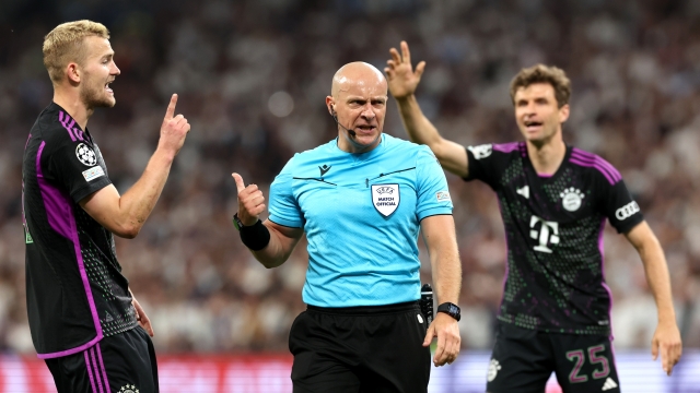 MADRID, SPAIN - MAY 08: Referee Szymon Marciniak looks on with Matthijs de Ligt and Thomas Mueller of Bayern Munich during the UEFA Champions League semi-final second leg match between Real Madrid and FC Bayern München at Estadio Santiago Bernabeu on May 08, 2024 in Madrid, Spain. (Photo by Alexander Hassenstein/Getty Images)