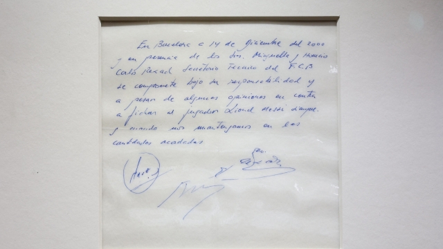 A photograph taken on May 8, 2024 shows the napkin on which the 13-year-old Argentinian football player Lionel Messi was promised his first contract with FC Barcelona, during a photocall at Bonhams, in London, ahead of its auction. The original napkin in blue ink is being offered at Bonhams on behalf of Argentine agent, Horacio Gaggioli, in an online auction starting on 8th and running until 17th May. The starting price is £300,000. (Photo by Adrian DENNIS / AFP)