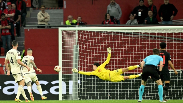 Roma's Serbian goalkeeper #99 Mile Svilar (C) jumps for the ball during the UEFA Europa League semi final second leg football match between Bayer Leverkusen and ASC Roma in Leverkusen, on May 9, 2024. (Photo by INA FASSBENDER / AFP)