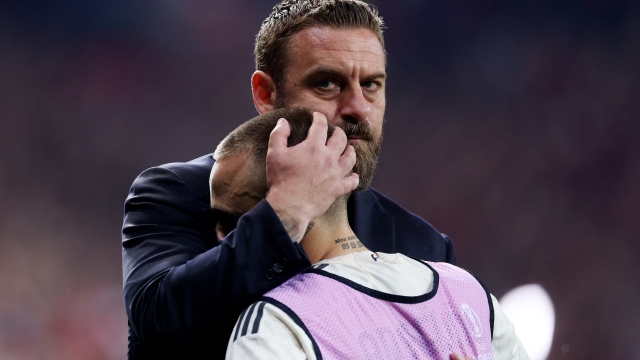 LEVERKUSEN, GERMANY - MAY 09: Daniele De Rossi, Head Coach of AS Roma, consoles Angelino of AS Roma at full-time following the team's defeat in the UEFA Europa League 2023/24 Semi-Final second leg match between Bayer 04 Leverkusen and AS Roma at BayArena on May 09, 2024 in Leverkusen, Germany. (Photo by Dean Mouhtaropoulos/Getty Images)