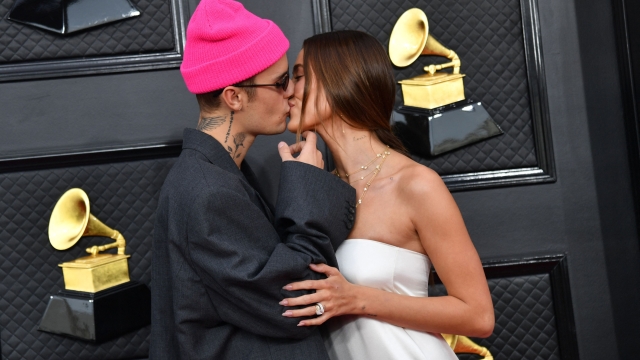 (FILES) Canadian singer-songwriter Justin Bieber (L) and US model Hailey Bieber arrive for the 64th Annual Grammy Awards at the MGM Grand Garden Arena in Las Vegas on April 3, 2022. US model Hailey Bieber and husband Canadian singer-songwriter Justin Bieber are expecting a baby, according to an Instagram post by Bieber on May 9, 2024 showing photos of her pregnant belly. (Photo by ANGELA  WEISS / AFP)