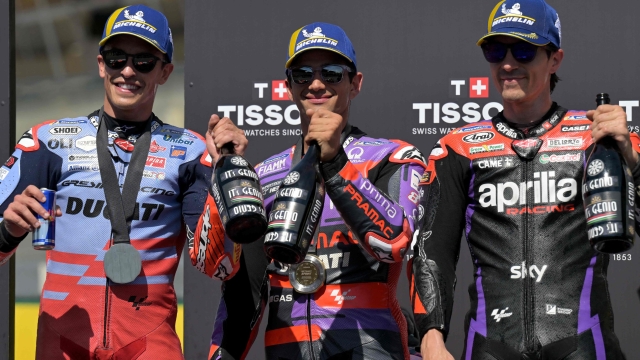 (From L) Second-placed Gresini Racing MotoGP's Spanish rider Marc Marquez, race winner Prima Pramac Racing's Spanish rider Jorge Martin and third-placed Aprilia Racing's Spanish rider Maverick Vinales pose on the podium of the French MotoGP Grand Prix sprint race at the Bugatti circuit in Le Mans, northwestern France, on May 11, 2024. (Photo by Lou BENOIST / AFP)