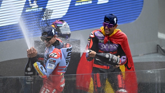 Second-placed Gresini Racing MotoGP's Spanish rider Marc Marquez (L) and winner Prima Pramac Racing's Spanish rider Jorge Martin celebrate on the podium of the French MotoGP Grand Prix race at the Bugatti circuit in Le Mans, northwestern France, on May 12, 2024. (Photo by JULIEN DE ROSA / AFP)