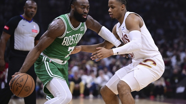 Boston Celtics guard Jaylen Brown (7) drives on Cleveland Cavaliers forward Isaac Okoro, right, during the first half of Game 4 of an NBA basketball second-round playoff series Monday, May 13, 2024, in Cleveland. (AP Photo/David Dermer)
