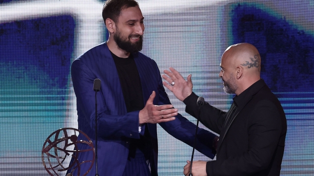 Paris Saint-Germain's Italian goalkeeper Gianluigi Donnarumma (L) receives the Best Ligue 1 Goalkeeper Award from French former goalkeaper Jérémie Janot during the 32nd edition of the UNFP (French National Professional Football players Union) trophy ceremony, in Paris on May 13, 2024. (Photo by FRANCK FIFE / AFP)