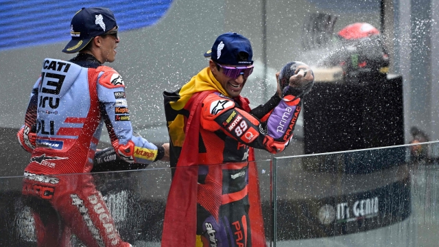 Race winner Prima Pramac Racing's Spanish rider Jorge Martin (R) and second-placed Gresini Racing MotoGP's Spanish rider Marc Marquez celebrate on the podium of the French MotoGP Grand Prix race at the Bugatti circuit in Le Mans, northwestern France, on May 12, 2024. (Photo by JULIEN DE ROSA / AFP)