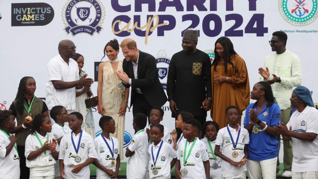 Lagos Polo Club President Bode Makanjuola (L), his wife Moyo Makanjuola (2ndL), Britain's Meghan (3rdL), Duchess of Sussex, Britain's Prince Harry (4thL)), Duke of Sussex, Nigeria Chief of Defense Staff Christopher Musa (3ndR), his wife Lilian Musa (2ndR) and Regional head of Equity Research for West Africa at Standard Bank group, Muyiwa Oni (R) pose for a photo with children after a charity polo game at the Ikoyi Polo Club in Lagos on May 12, 2024 as they visit Nigeria as part of celebrations of Invictus Games anniversary. (Photo by Kola Sulaimon / AFP)