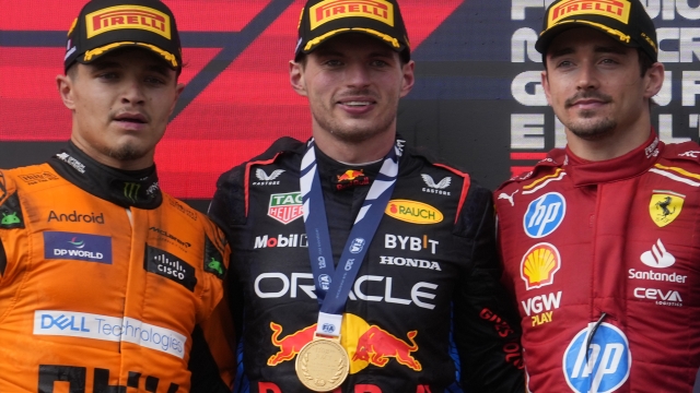 Winner Red Bull driver Max Verstappen of the Netherlands, center, is flanked on the podium with second placed McLaren driver Lando Norris of Britain, left, and third Ferrari driver Charles Leclerc of Monaco after the Italy's Emilia Romagna Formula One Grand Prix race at the Dino and Enzo Ferrari racetrack in Imola, Italy, Sunday, May 19, 2024. (AP Photo/Luca Bruno)