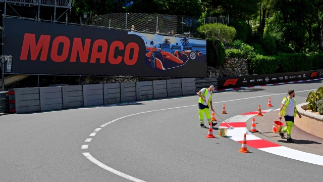 Workers repaint the curbs of the Circuit de Monaco's hairpin corner on May 22, 2024 in Monaco, four days ahead of the Formula One Monaco Grand Prix. (Photo by Andrej ISAKOVIC / AFP)