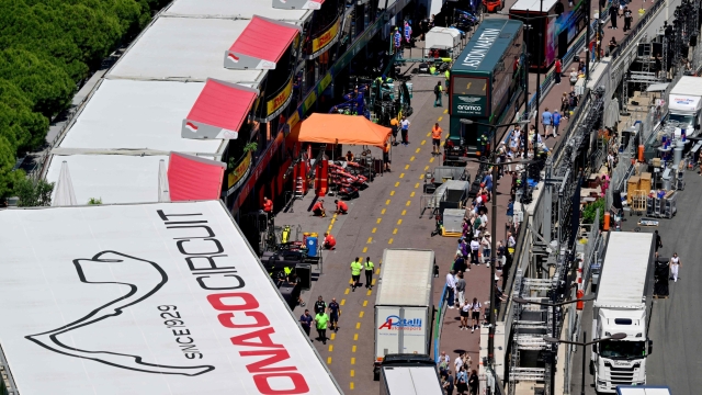 Mechanics and team staff work in the F1 pit lane of the Circuit de Monaco on May 22, 2024 in Monaco, four days ahead of the Formula One Monaco Grand Prix. (Photo by Andrej ISAKOVIC / AFP)