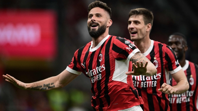 AC Milan's French forward #09 Olivier Giroud (L) celebrates after scoring his team's second goal during the Italian Serie A football match between AC Milan and Salernitana at San Siro Stadium, in Milan on May 25, 2024.  as the last match by coach (Photo by MARCO BERTORELLO / AFP)