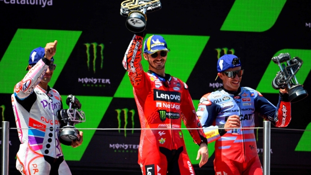 (From L) Second-placed Ducati Spanish rider Jorge Martin, winner Ducati Italian rider Francesco Bagnaia and third-placed Ducati Spanish rider Marc Marquez celebrate on the podium after the MotoGP Race of the Moto Grand Prix of Catalonia at the Circuit de Catalunya on May 26, 2024 in Montmelo on the outskirts of Barcelona. (Photo by Josep LAGO / AFP)