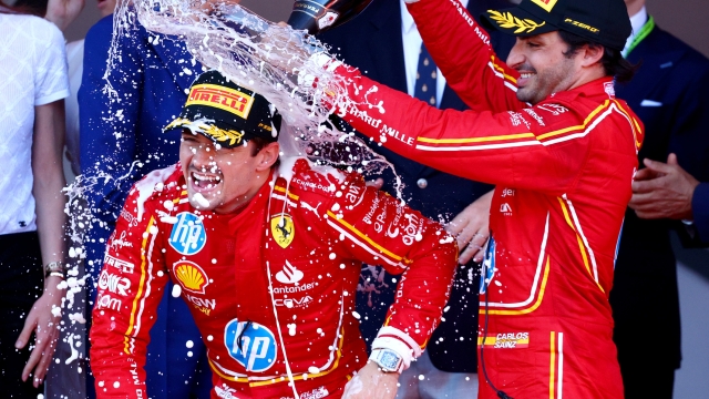 MONTE-CARLO, MONACO - MAY 26: Race winner Charles Leclerc of Monaco and Ferrari and Third placed Carlos Sainz of Spain and Ferrari celebrate on the podium during the F1 Grand Prix of Monaco at Circuit de Monaco on May 26, 2024 in Monte-Carlo, Monaco. (Photo by Clive Rose/Getty Images)
