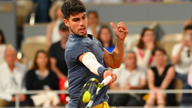 PARIS, FRANCE - MAY 26: Carlos Alcaraz of Spain plays a forehand against J.J. Wolf of United States in the Men's Singles first round match on Day One of the 2024 French Open at Roland Garros on May 26, 2024 in Paris, France. (Photo by Clive Mason/Getty Images)