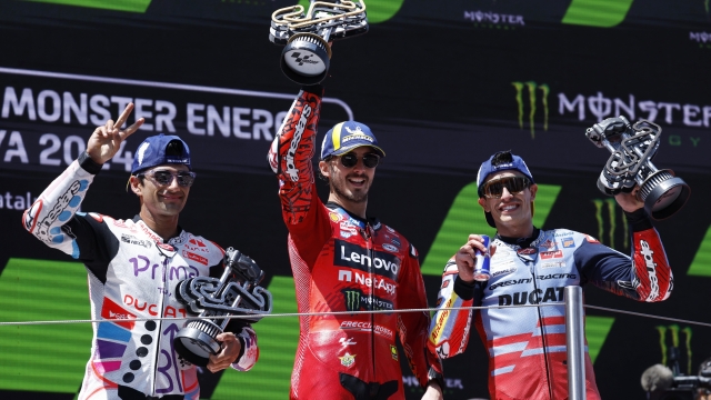Ducati rider Francesco Bagnaia, centre, of Italy, winner of the MotoGP race of the Catalunya Motorcycle Grand Prix, celebrates on the podium with second placed Ducati rider Jorge Martin, left, of Spain, and third placed Ducati rider Marc Marquez, of Spain, at the Catalunya racetrack in Montmelo, near Barcelona, Spain, Sunday, May 26, 2024. (AP Photo/Joan Monfort)