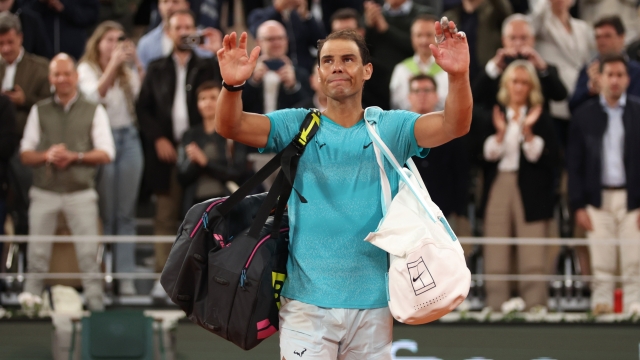 PARIS, FRANCE - MAY 27: Rafael Nadal of Spain waves to the crowd as he walks off after his defeat by Alexander Zverev of Germany in the Men's Singles first round match on Day Two of the 2024 French Open at Roland Garros on May 27, 2024 in Paris, France. (Photo by Clive Brunskill/Getty Images)