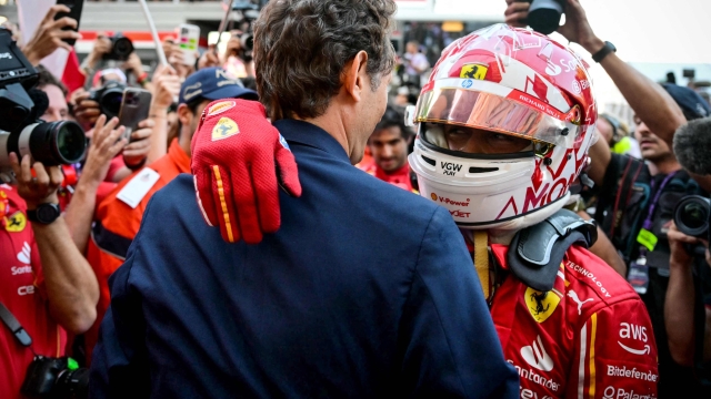 Ferrari's Monegasque driver Charles Leclerc (R) celebrates with John Elkann (L), CEO of the holding company Exor which controls Ferrari, after winning the Formula One Monaco Grand Prix on May 26, 2024 at the Circuit de Monaco. (Photo by ANDREJ ISAKOVIC / AFP)