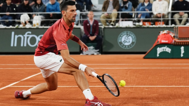 Serbia's Novak Djokovic plays a forehand return to Spain's Roberto Carballes Baena during their men's singles match on Court Philippe-Chatrier on day five of the French Open tennis tournament at the Roland Garros Complex in Paris on May 30, 2024. (Photo by Dimitar DILKOFF / AFP)