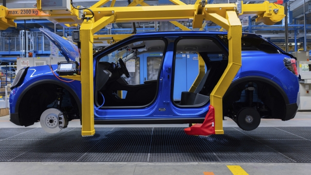 Ford Explorer electric cars stand in the hall at the start of production, in Cologne, Germany, Tuesday June 4, 2024. This is the first electric car produced by Ford in Europe. Around two billion euros have been invested in the Cologne production site. (Rolf Vennenbernd/dpa via AP)
