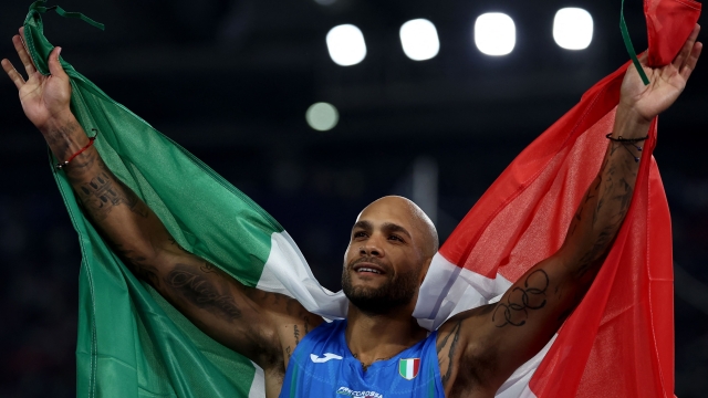 Italy's athlete Lamont Marcell Jacobs celebrates after winning gold medal in the men's 100m final during the European Athletics Championships at the Olympic stadium in Rome on June 8, 2024. (Photo by Anne-Christine POUJOULAT / AFP)