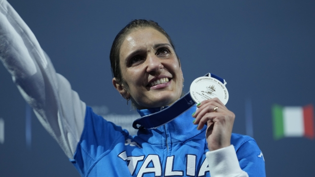 FILE - Italy's Arianna Errigo celebrates on the podium her silver medal after the women's Individual Foil final against Italy's Alice Volpi, at the Fencing World Championships in Milan, Italy, on July 26, 2023. Fencer Arianna Errigo and high jumper Gianmarco Tamberi were named as Italy’s flagbearers Monday, April 29, 2024 for the Paris Olympics opening ceremony. (AP Photo/Luca Bruno)