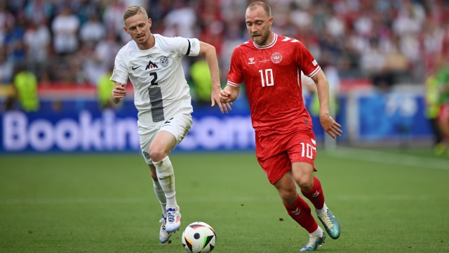 STUTTGART, GERMANY - JUNE 16: Christian Eriksen of Denmark runs with the ball whilst under pressure from Zan Karnicnik of Slovenia during the UEFA EURO 2024 group stage match between Slovenia and Denmark at Stuttgart Arena on June 16, 2024 in Stuttgart, Germany.   (Photo by Clive Mason/Getty Images)