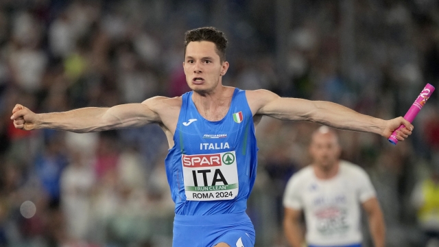 Filippo Tortu, of Italy, crosses the finish line to win the men's 4X 100 meters relay final at the European Athletics Championships in Rome, Wednesday, June 12, 2024. (AP Photo/Stefano Costantino)