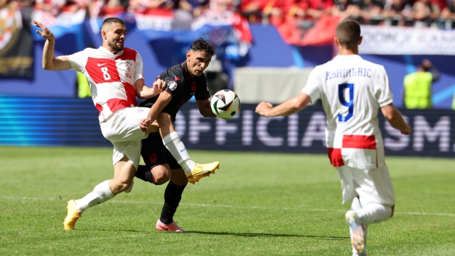 epa11422652 Qazim Laci of Albania (C) in action against Mateo Kovacic (L) and Andrej Kramaric of Croatia during the UEFA EURO 2024 group B match between Croatia and Albania in Hamburg, Germany, 19 June 2024.  EPA/ABEDIN TAHERKENAREH