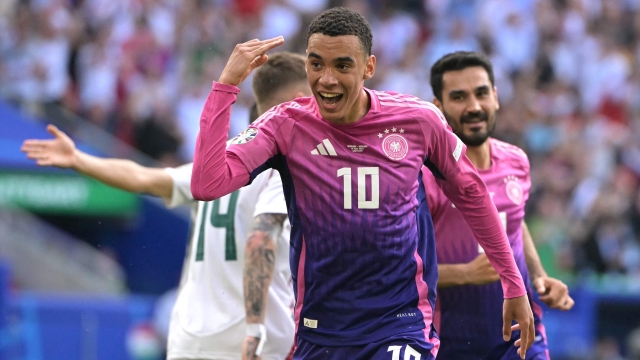 Germany's midfielder #10 Jamal Musiala (C) celebrates after scoring the opening goal during the UEFA Euro 2024 Group A football match between Germany and Hungary at the Stuttgart Arena in Stuttgart on June 19, 2024. (Photo by DAMIEN MEYER / AFP)