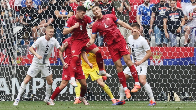 epa11425443 Luka Jovic of Serbia (L) and Nikola Milenkovic of Serbia (R) in action during the UEFA EURO 2024 Group C soccer match between Slovenia and Serbia, in Munich, Germany, 20 June 2024.  EPA/MOHAMED MESSARA