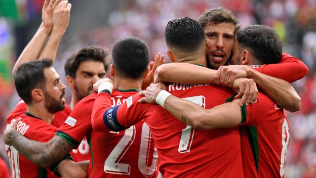 TOPSHOT - Portugal's midfielder #08 Bruno Fernandes (R) celebrates with Portugal's defender #04 Ruben Dias (2R) and Portugal's forward #07 Cristiano Ronaldo (3R) after scoring his team's third goal during the UEFA Euro 2024 Group F football match between Turkey and Portugal at the BVB Stadion in Dortmund on June 22, 2024. (Photo by INA FASSBENDER / AFP)