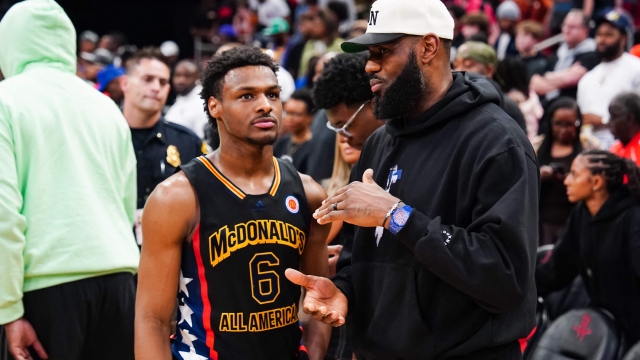 (FILES) Bronny James #6 of the West team talks to Lebron James of the Los Angeles Lakers after the 2023 McDonald's High School Boys All-American Game at Toyota Center on March 28, 2023 in Houston, Texas. Bronny James, the 19-year-old son of Los Angeles Lakers superstar LeBron James, was selected 55th overall by the Los Angeles Lakers in June 27's second round of the NBA Draft. Four-time NBA Most Valuable Player LeBron James, the 39-year-old Lakers playmaker who is a four-time NBA champion, has said he would like to play alongside his son next season -- in what would be the first father-son combination in NBA history. (Photo by Alex Bierens de Haan / GETTY IMAGES NORTH AMERICA / AFP)