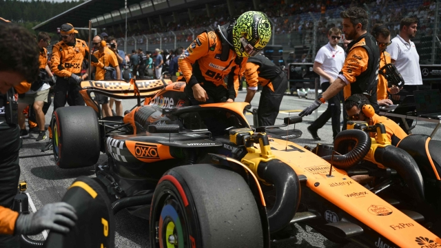 McLaren's British driver Lando Norris gets into his car ahead of the Formula One Austrian Grand Prix on the Red Bull Ring race track in Spielberg, Austria, on June 30, 2024. (Photo by Jure Makovec / AFP)