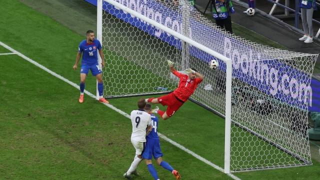 GELSENKIRCHEN, GERMANY - JUNE 30: Harry Kane of England scores his team's second goal past Martin Dubravka of Slovakia during the UEFA EURO 2024 round of 16 match between England and Slovakia at Arena AufSchalke on June 30, 2024 in Gelsenkirchen, Germany. (Photo by Dean Mouhtaropoulos/Getty Images)