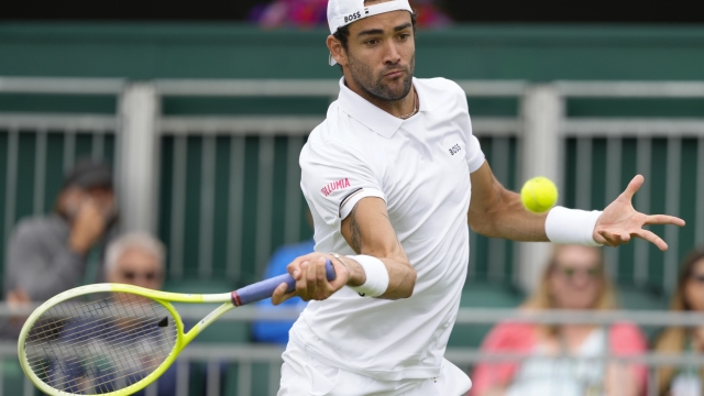 Matteo Berrettini plays a forehand return to Marton Fucsovics of Hungary during their first round match of the Wimbledon tennis championships in London, Monday, July 1, 2024. (AP Photo/Kirsty Wigglesworth)