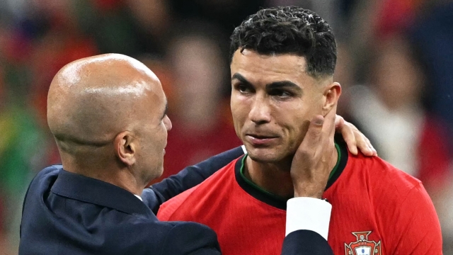 Portugal's forward #07 Cristiano Ronaldo (R) celebrates with Portugal's head coach Roberto Martinez after winning the UEFA Euro 2024 round of 16 football match between Portugal and Slovenia at the Frankfurt Arena in Frankfurt am Main on July 1, 2024. (Photo by PATRICIA DE MELO MOREIRA / AFP)