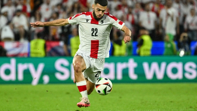 Georgia's forward #22 Georges Mikautadze runs with the ball during the UEFA Euro 2024 round of 16 football match between Spain and Georgia at the Cologne Stadium in Cologne on June 30, 2024. (Photo by Alberto PIZZOLI / AFP)